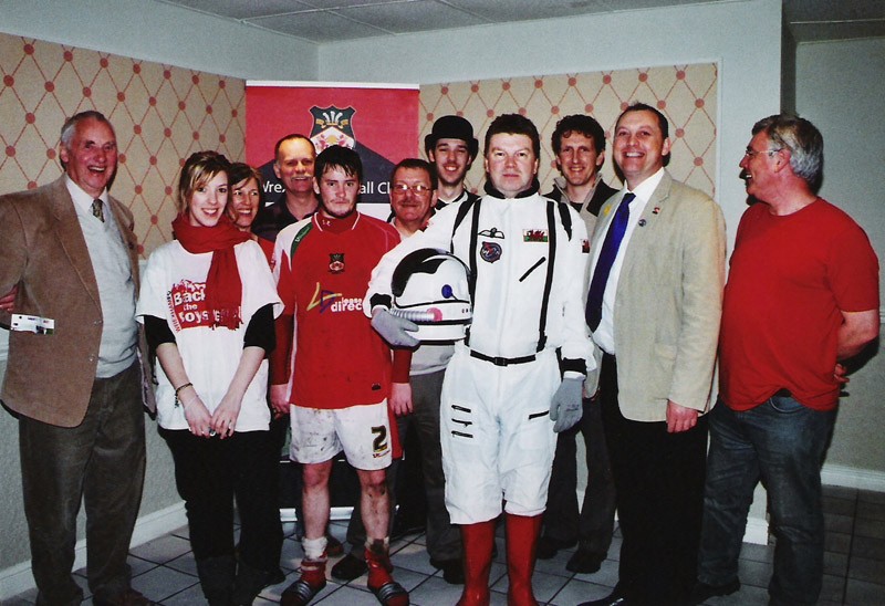 Group photo of match sponsors after the match. Clearly having fun. Man with spacesuit in the middle and the footballer Simon Spender looking bemused by it all.