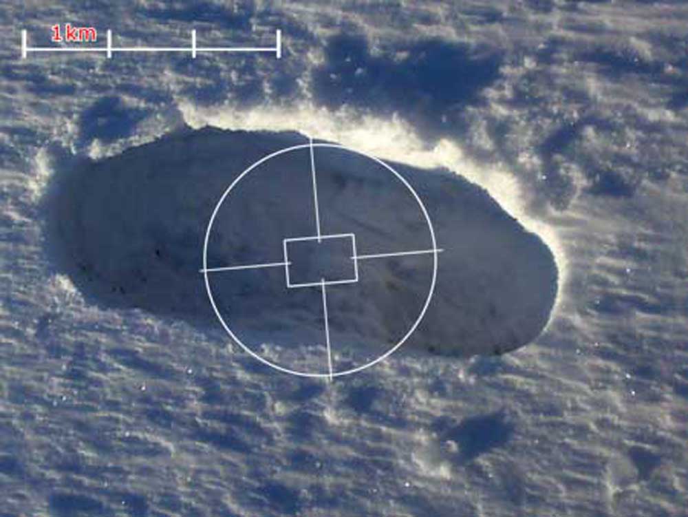 A snowy footprint with a map scale on it and a camera graticule