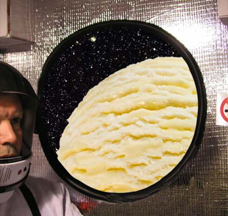 The port hole of a spacecraft with a planet outside that looks a lot like a scoop of ice cream. Dilwyn is looking out at it.